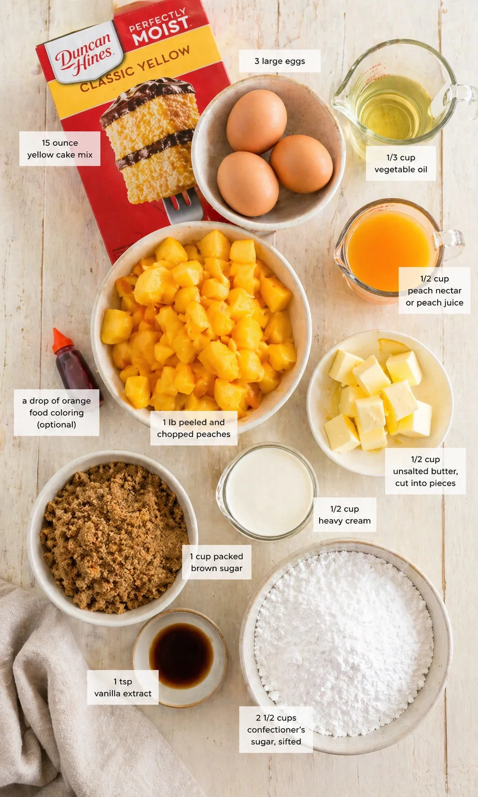 Overhead view of peach cake ingredients arranged on a wooden surface with labels.