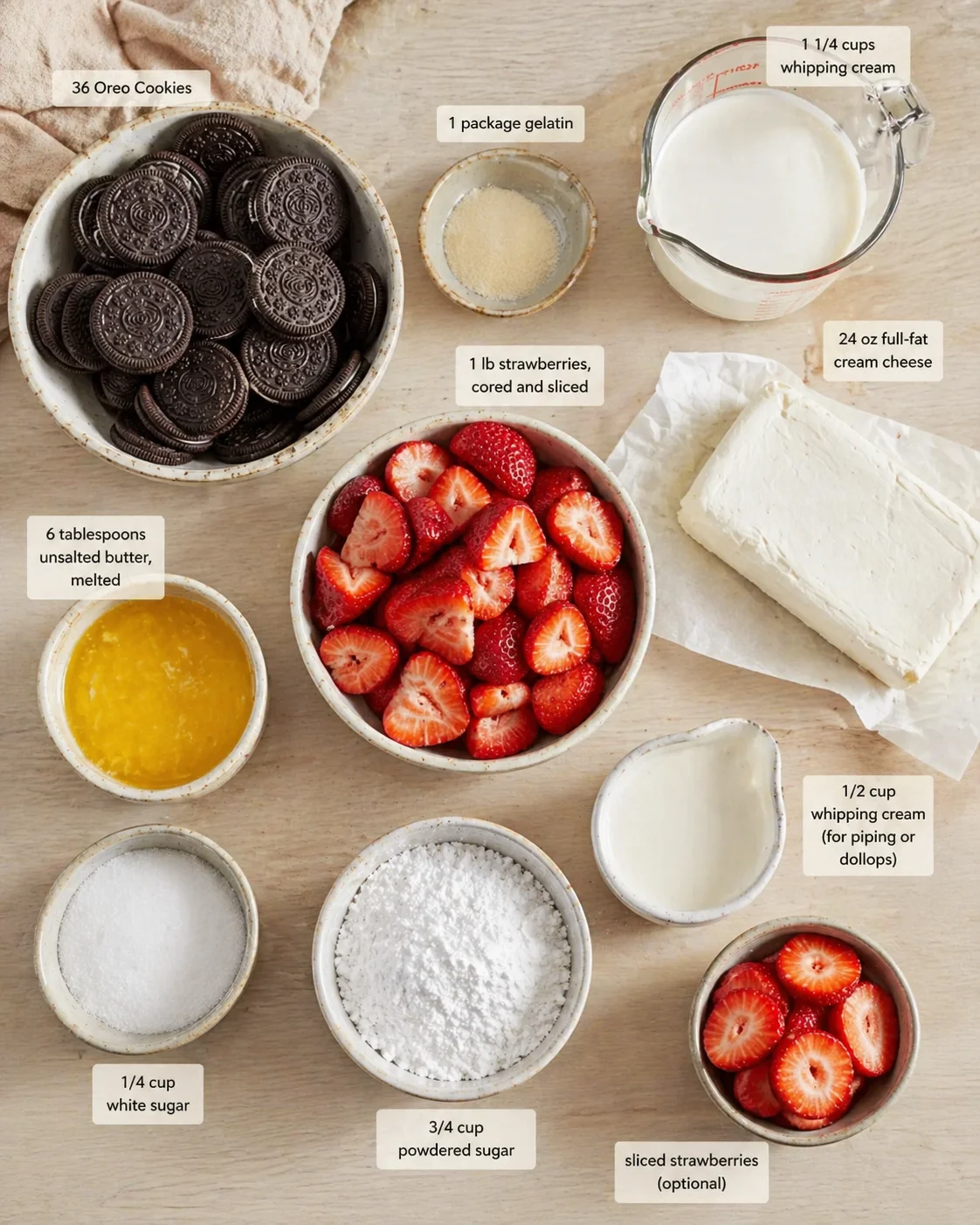 Top-down view of ingredients for a no-bake strawberry Oreo cheesecake, labeled bowls and jars.