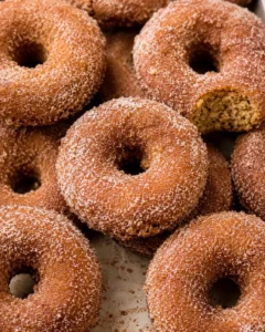 Close-up of warm, cinnamon-sugar coated baked apple cider donuts