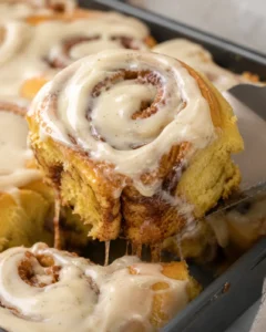 Creamy cinnamon rolls with swirls of pumpkin and vanilla bean frosting