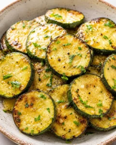 Tender zucchini slices with caramelized edges and a buttery garlic finish.