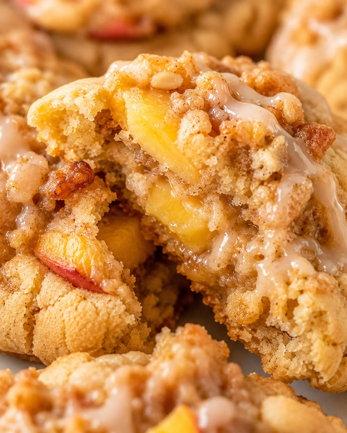 Close-up of soft, chewy peach cobbler cookies with juicy peaches and cinnamon.