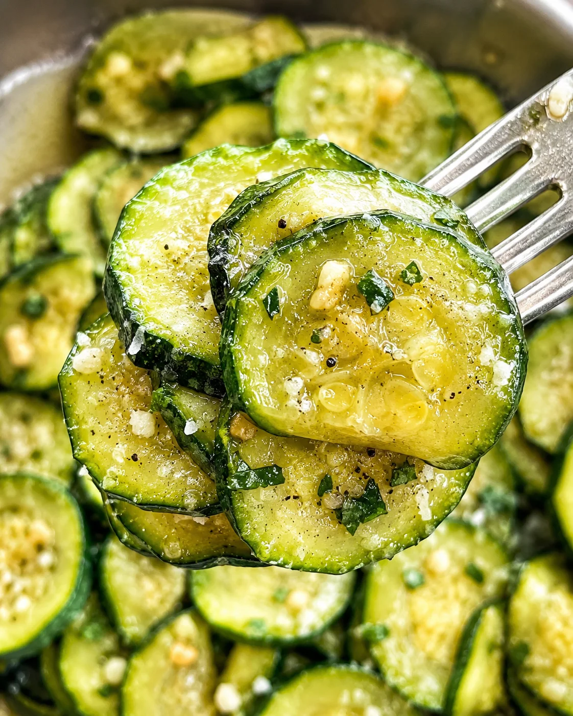 Close-up of sautéed zucchini slices with garlic and Parmesan cheese.