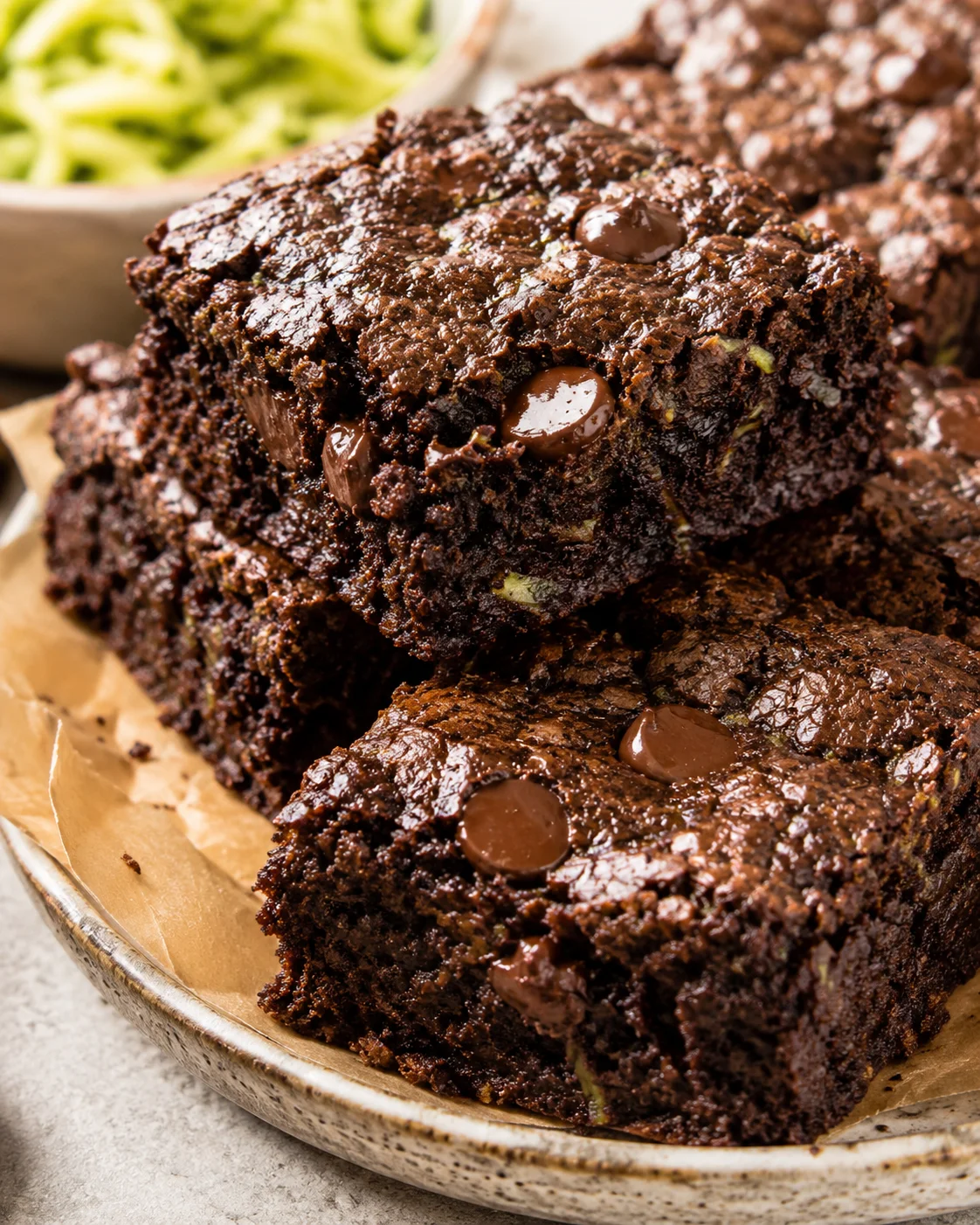 Close-up of rich, fudgy chocolate zucchini brownies with chocolate chips.