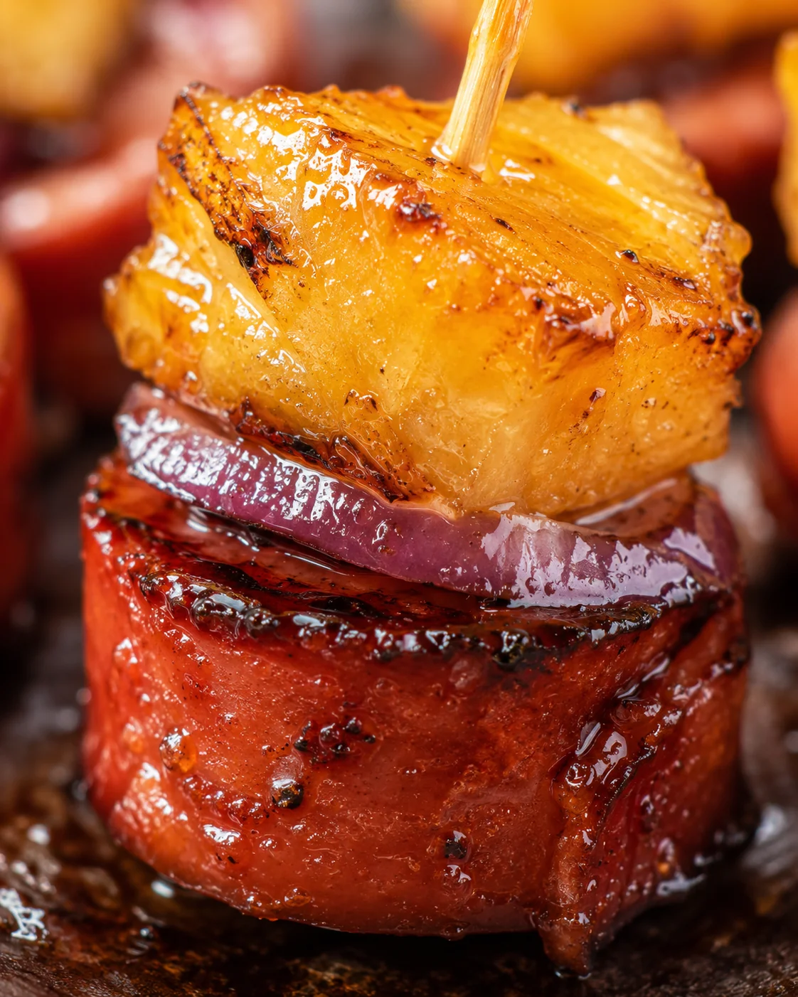Close-up of caramelized pineapple sausage bites with a glossy glaze