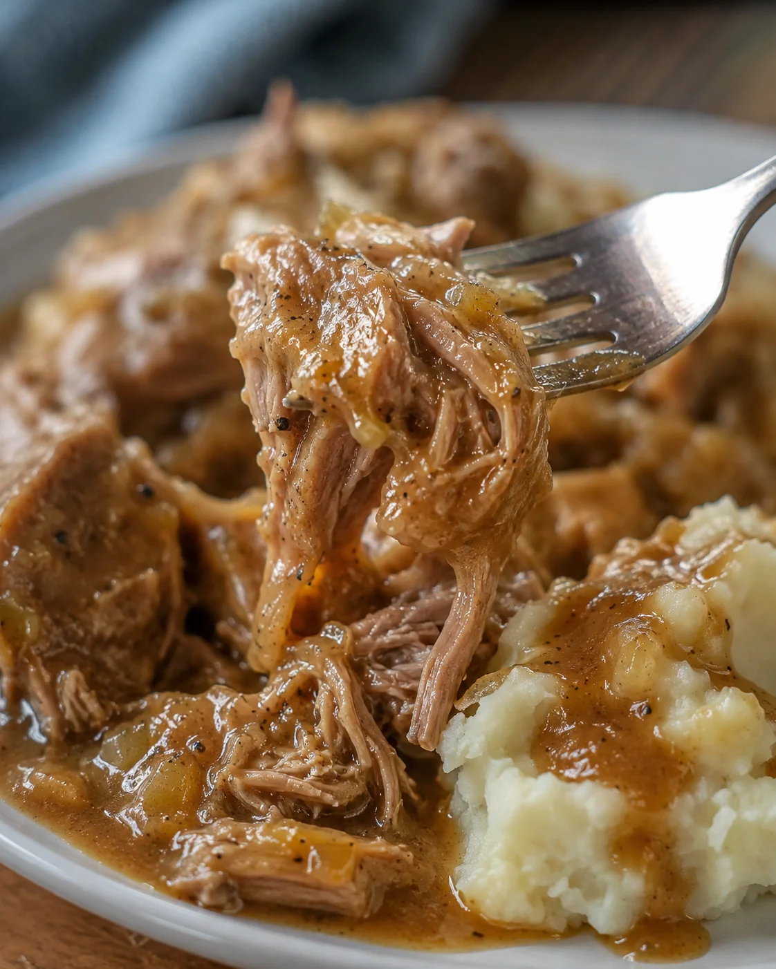 Tender pork roast served with flavorful gravy and mashed potatoes