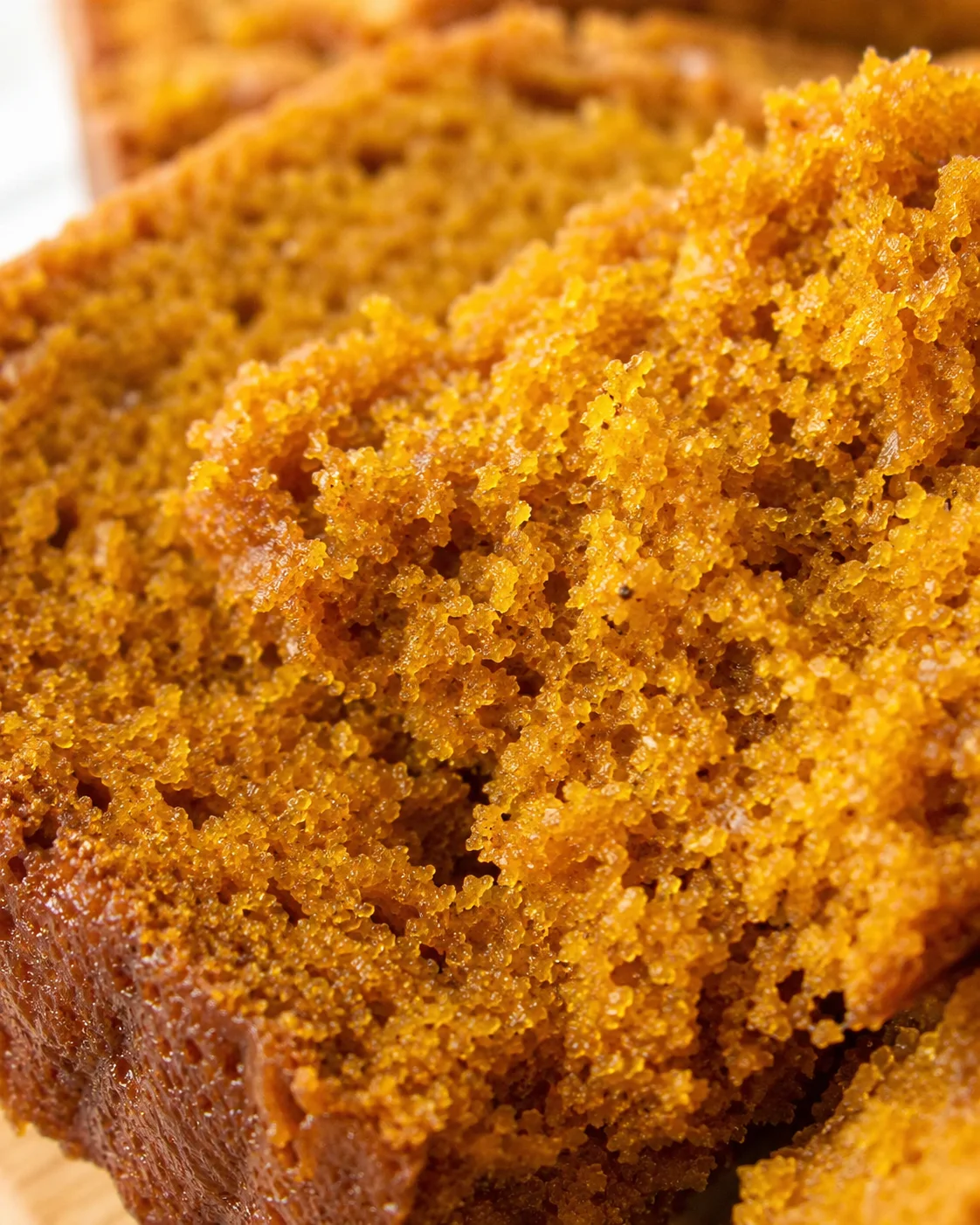 Close-up of moist, spiced pumpkin bread with a golden crust.