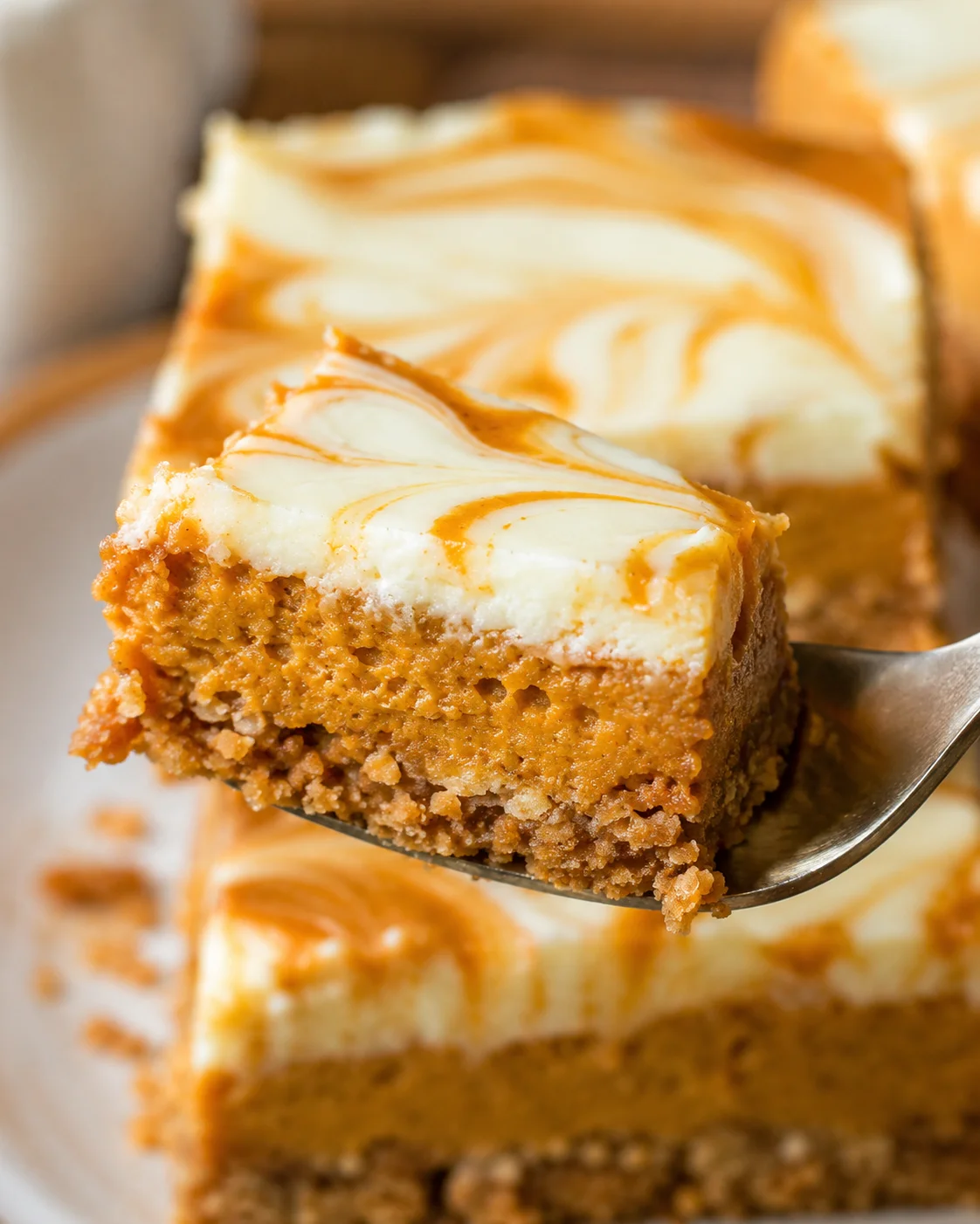 Delicious pumpkin cheesecake bars with marbled topping and buttery crust