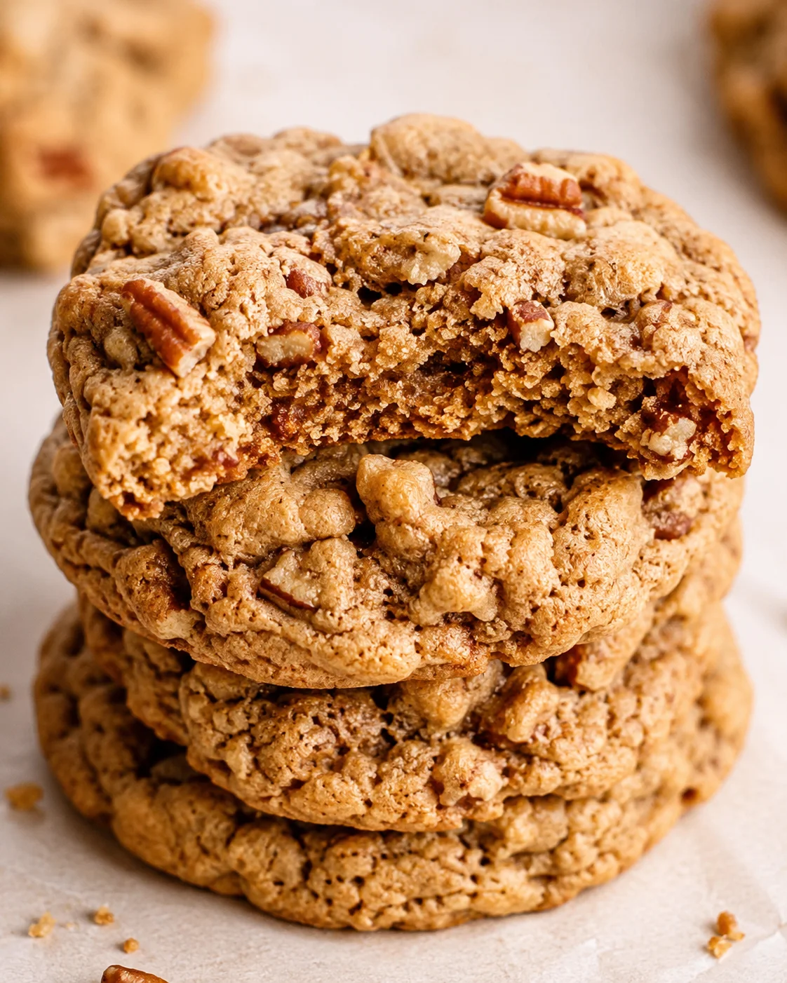Stack of soft, chewy maple pecan cookies with crunchy nuts and warm spices