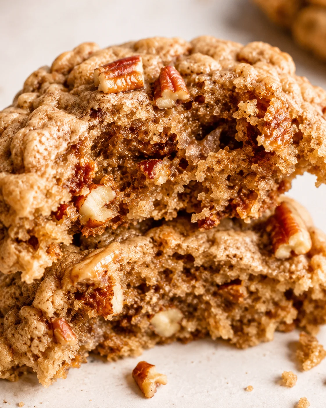 Close-up of soft, chewy maple pecan cookies with chopped pecans on top