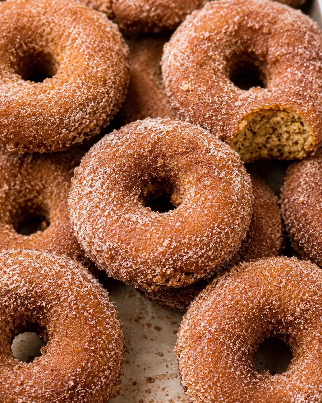 Close-up of warm, cinnamon-sugar coated baked apple cider donuts
