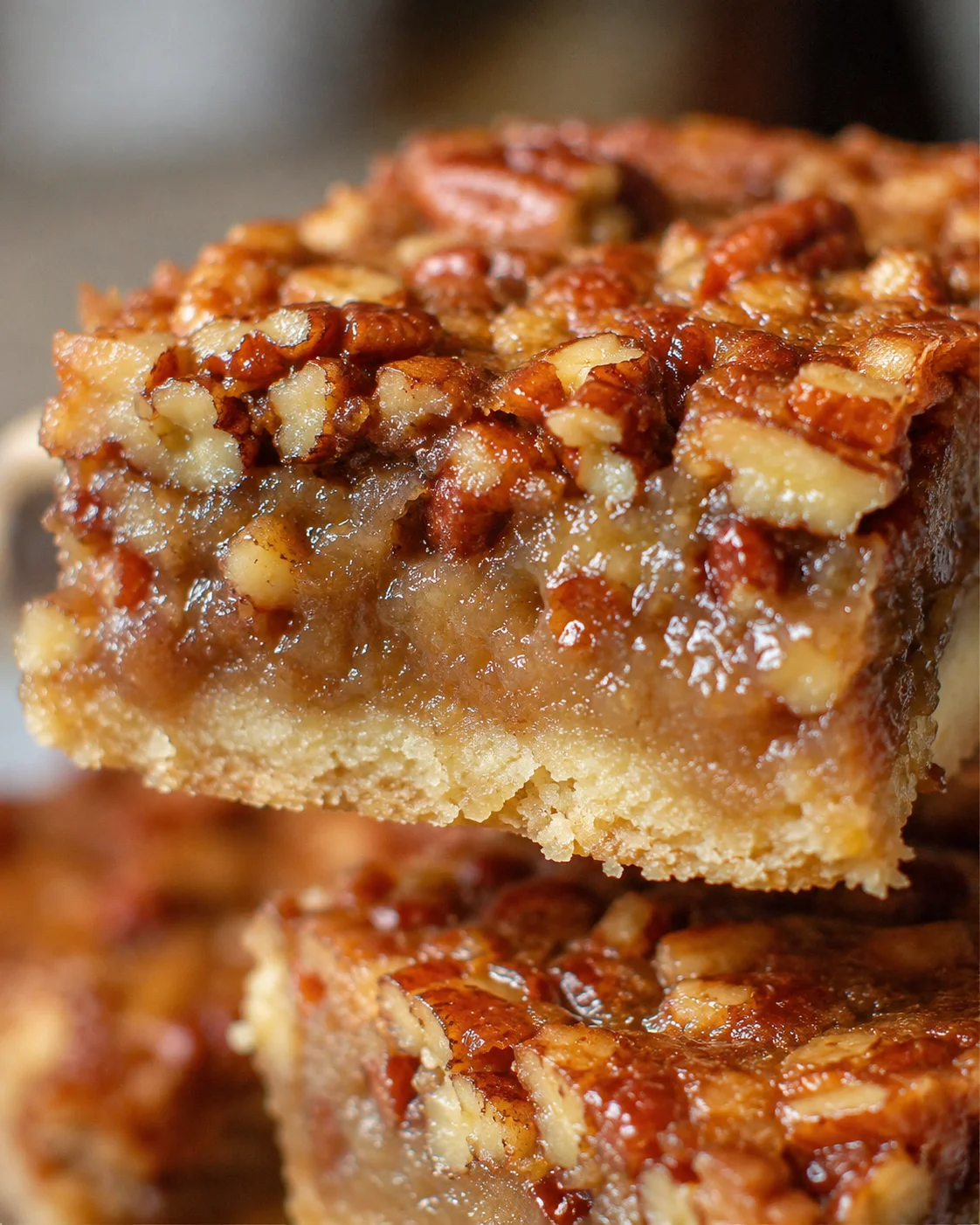 Close-up image of delicious pecan pie bars with a crunchy topping.