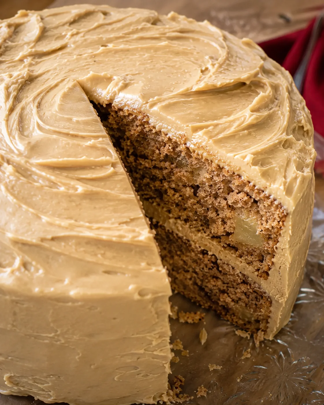 Delicious apple spice cake topped with creamy caramel icing and fresh apple chunks