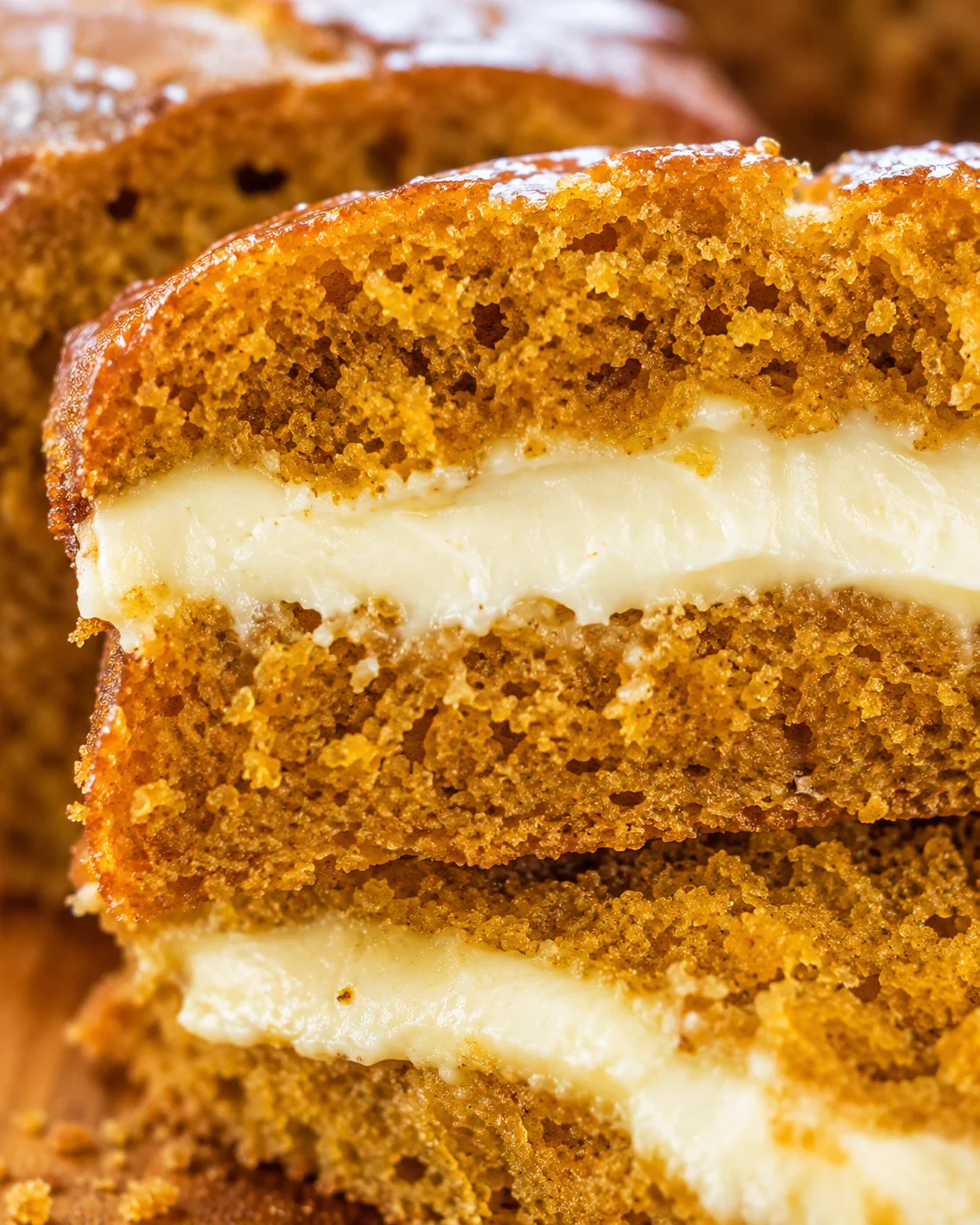 Close-up of moist pumpkin bread with creamy cheesecake filling swirl.