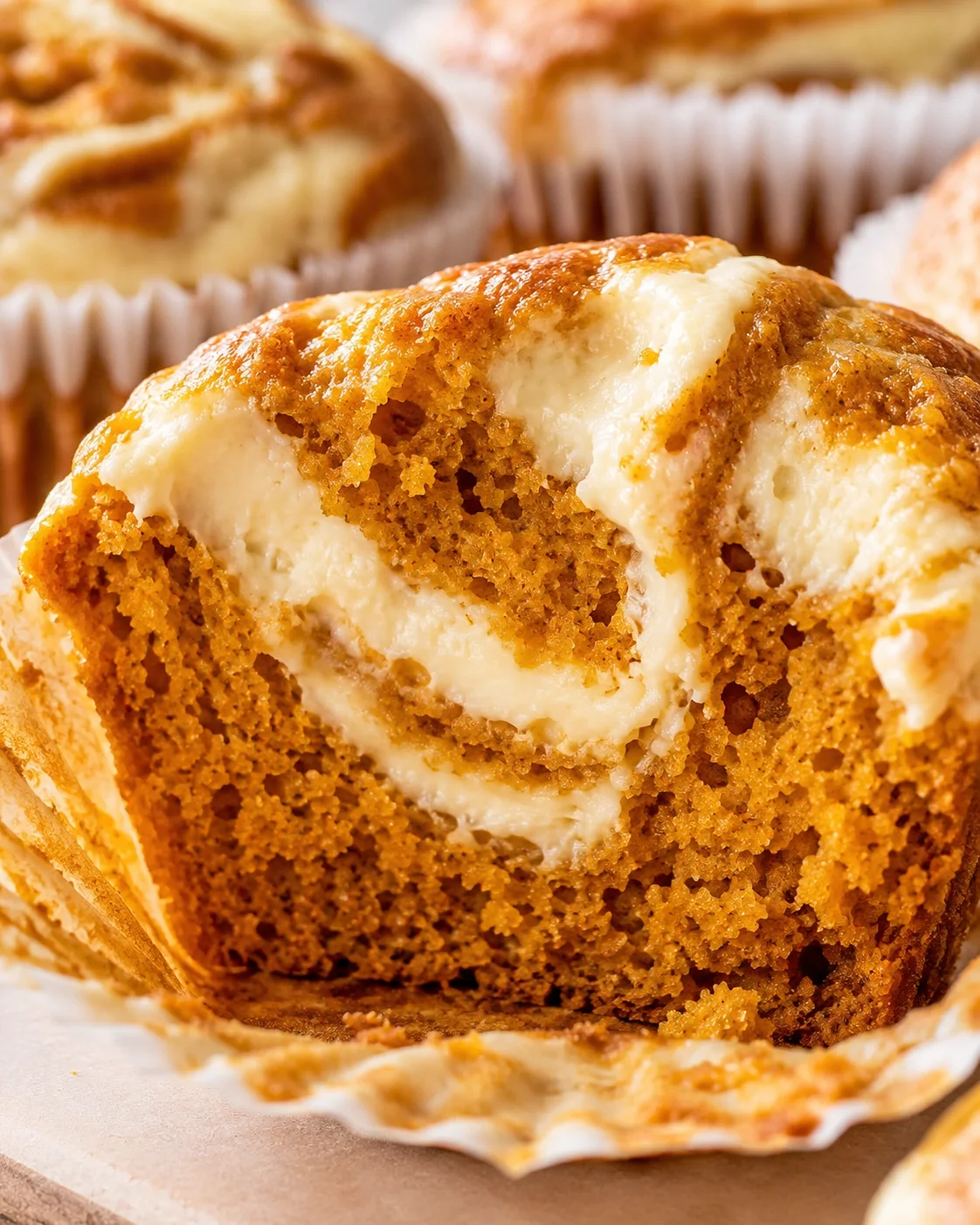 Close-up of moist pumpkin muffins topped with creamy swirl