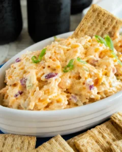 Bowl of 5 minute crack dip with crackers and sliced green onion garnish