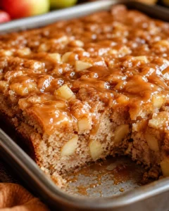 Delicious caramel apple sheet cake topped with caramel glaze in a large tray