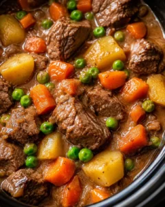 Close-up of hearty beef stew with vegetables in a slow cooker.