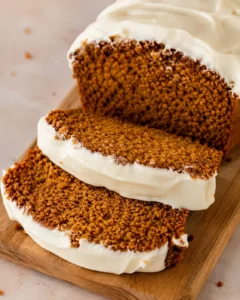 Moist pumpkin bread topped with creamy, tangy cream cheese frosting, perfect for fall.
