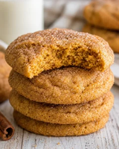 Stack of soft, chewy pumpkin snickerdoodle cookies with cinnamon sugar coating