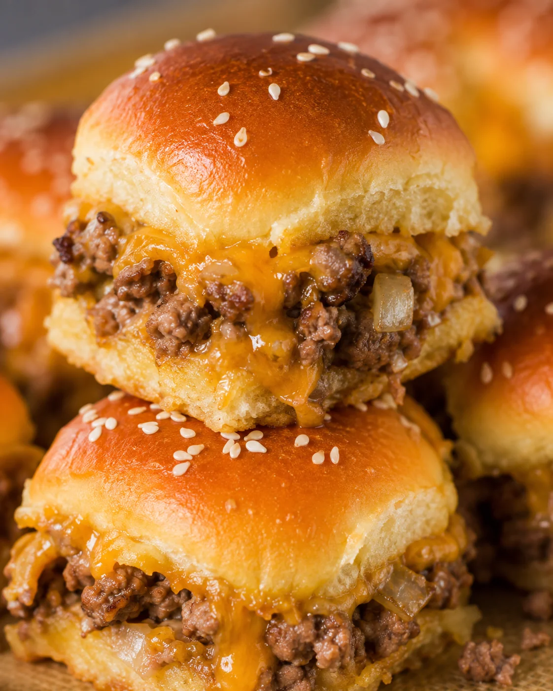 Cheeseburger slider stack with melty cheddar and sesame-topped rolls