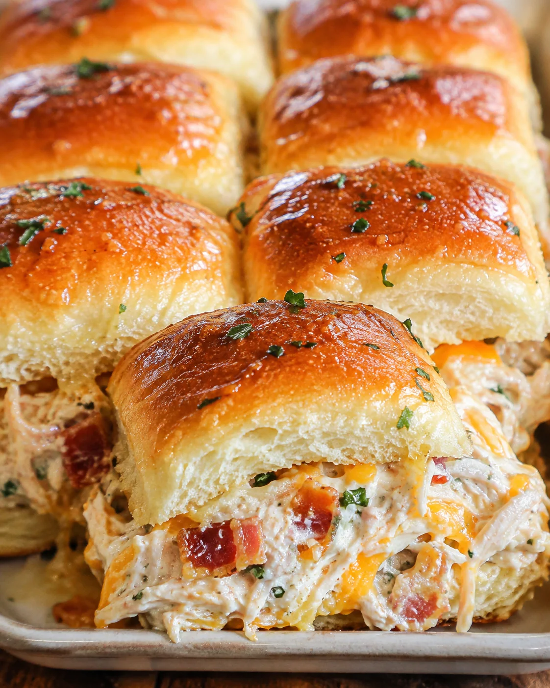 Tray of baked Chicken Bacon Ranch Sliders with glossy tops and creamy filling