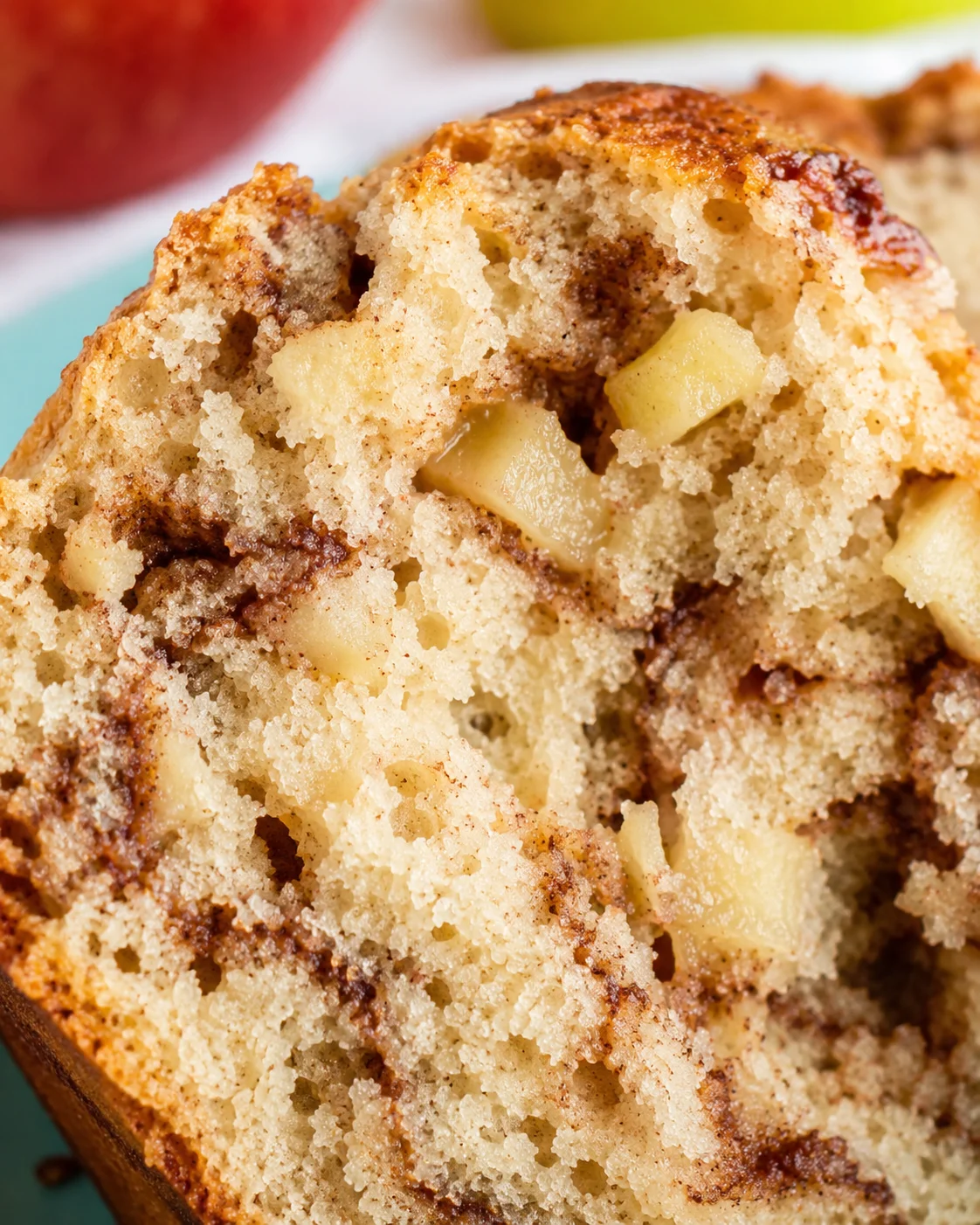 Close-up of moist, freshly baked apple cinnamon bread with apple chunks and cinnamon swirl