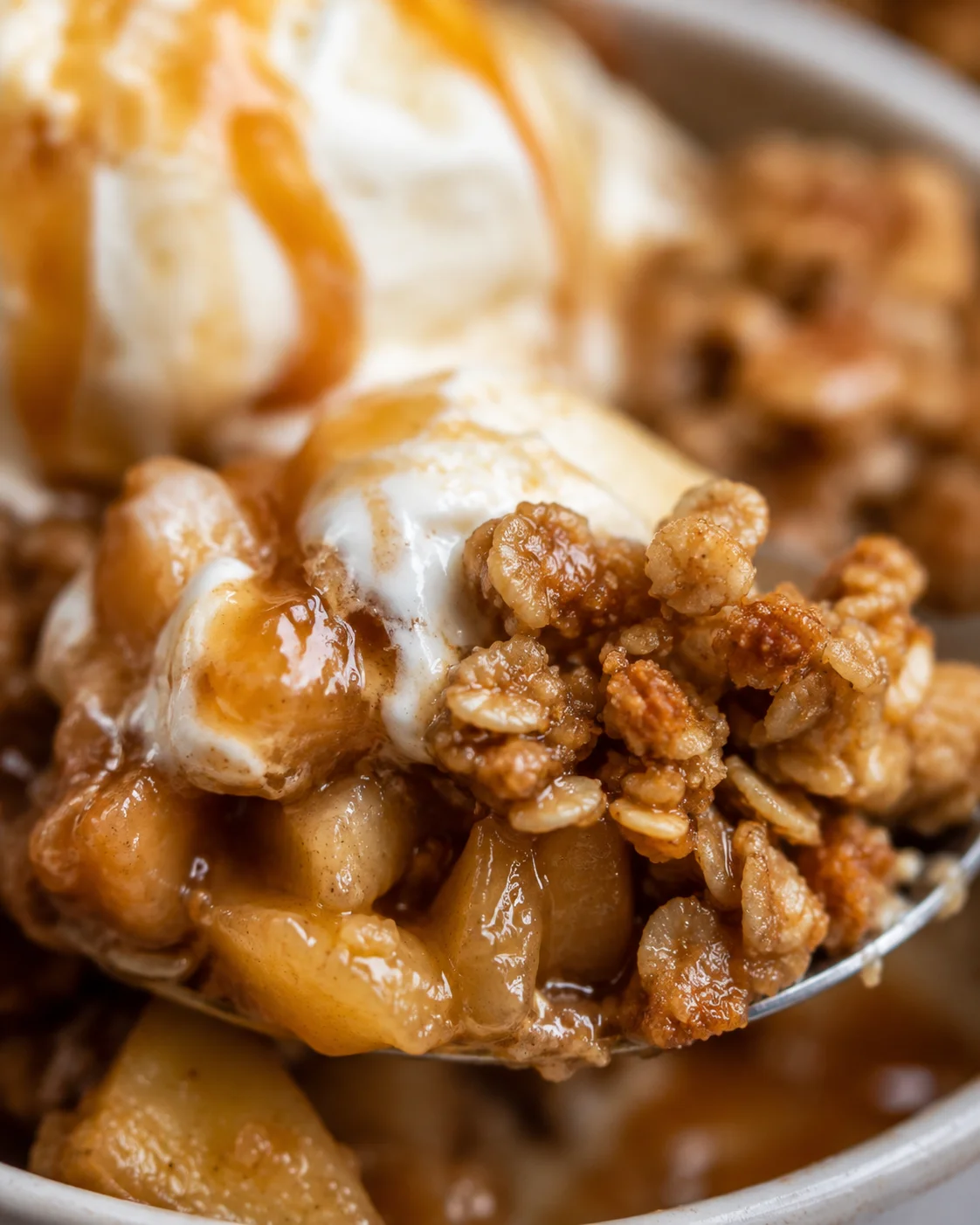 Close-up of warm gluten-free apple crisp with oats and caramel sauce.