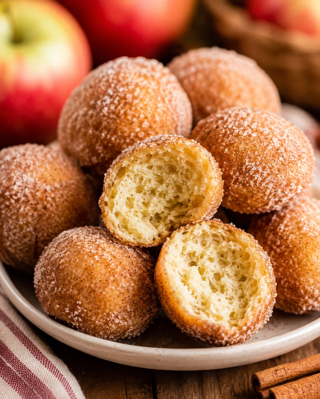 Platter of freshly baked apple cider donuts with cinnamon sugar coating.