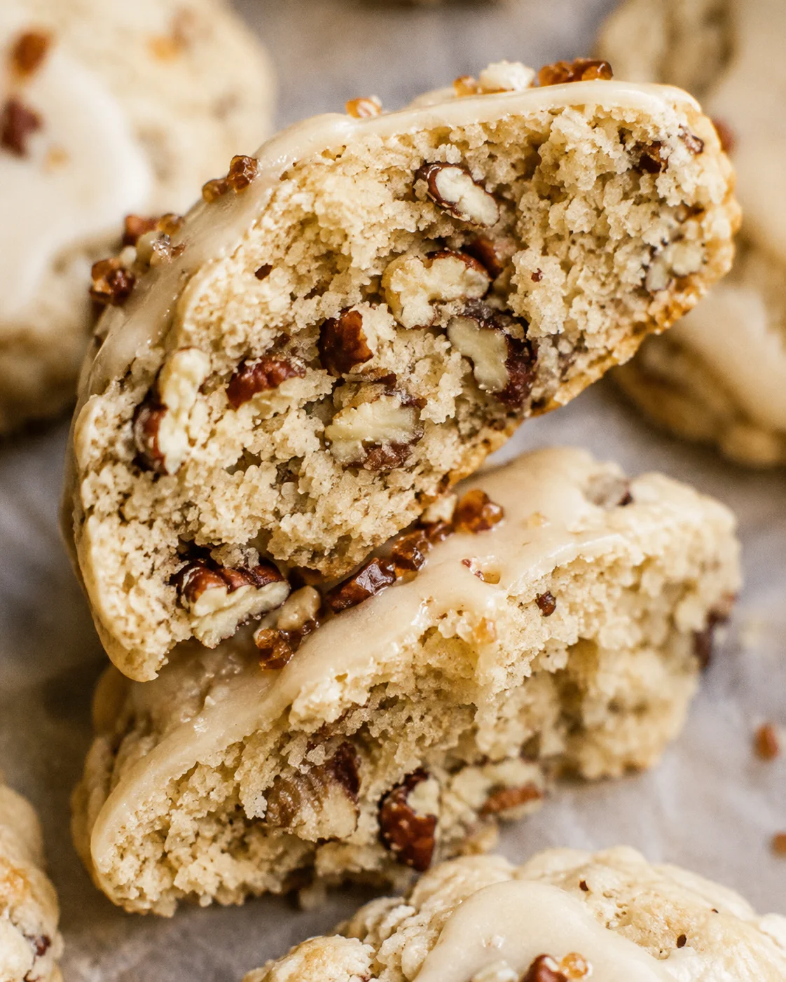 Close-up of sliced pecan maple cookies with glaze and nuts