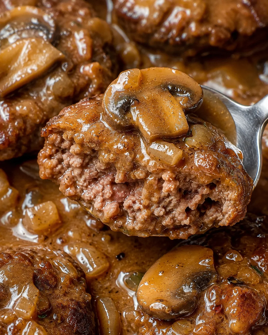 Juicy Salisbury steak patties smothered in rich mushroom gravy on a plate.
