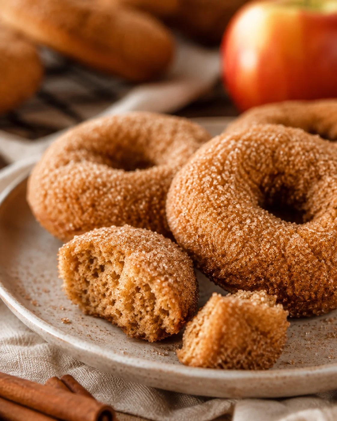 Close-up of delicious baked apple cider donuts with cinnamon-sugar coating.