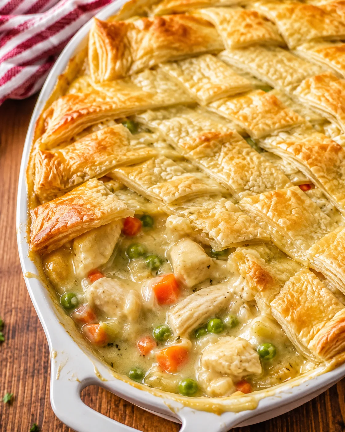 Delicious chicken pot pie casserole topped with puff pastry lattice.