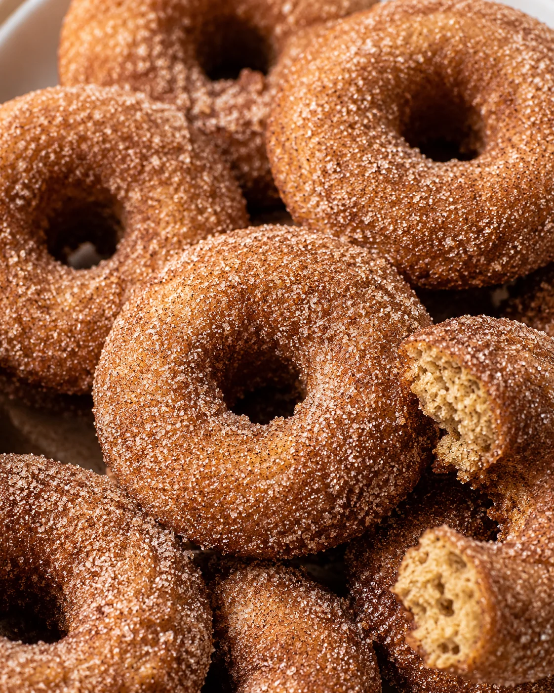 Close-up of golden baked apple cider donuts with sugar coating.