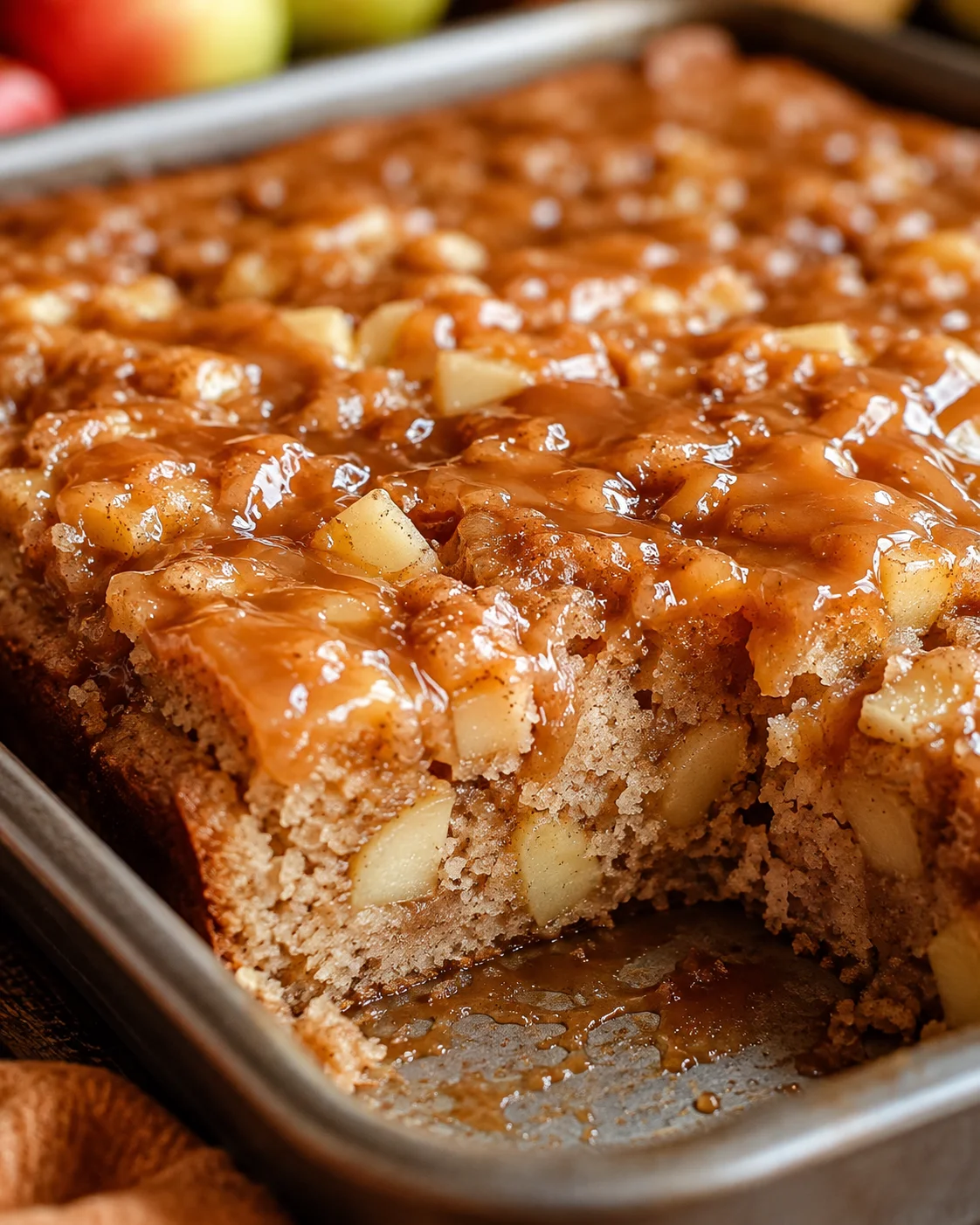 Delicious caramel apple sheet cake topped with caramel glaze in a large tray