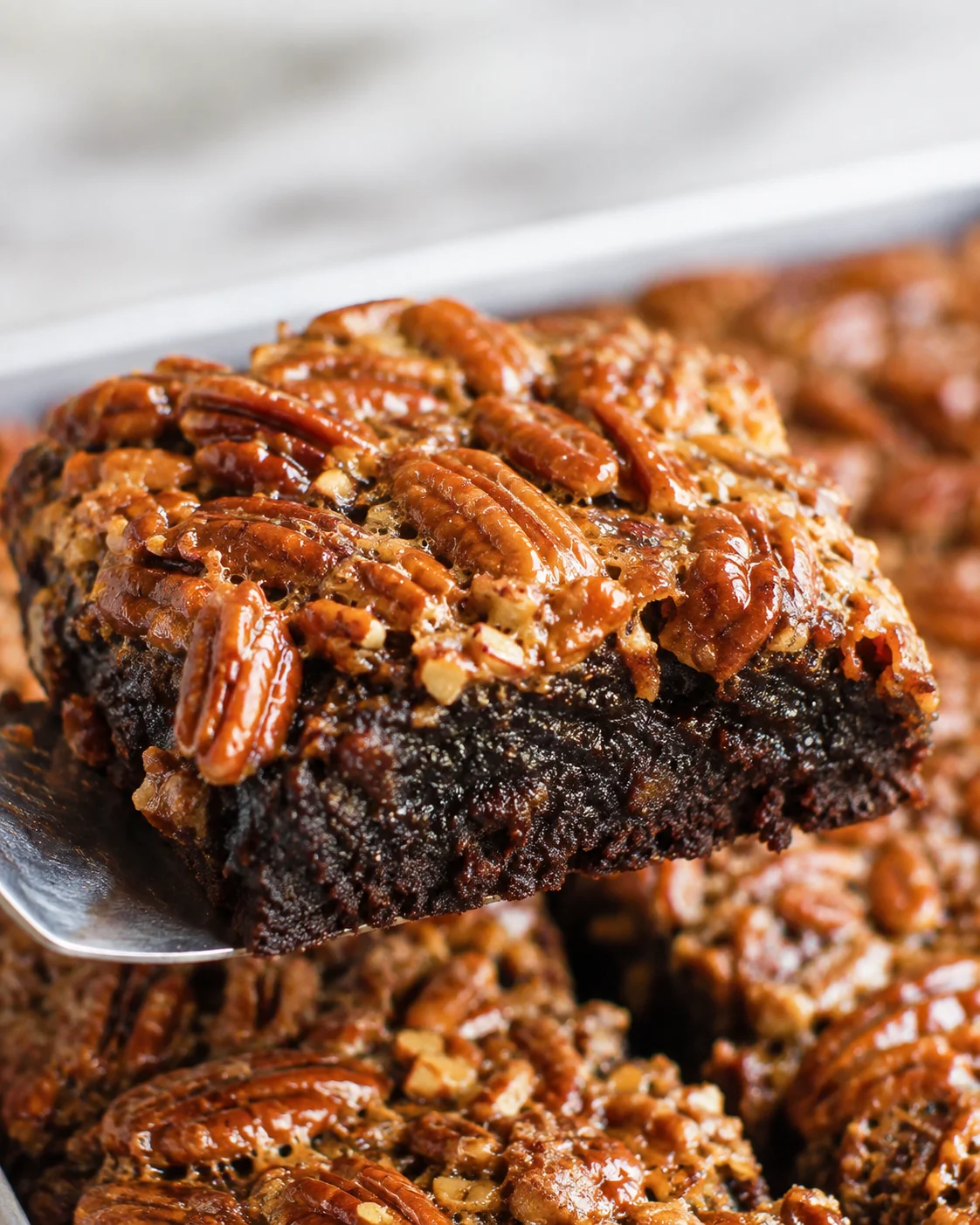 Fudgy chocolate brownie topped with a glossy, nutty pecan pie layer.