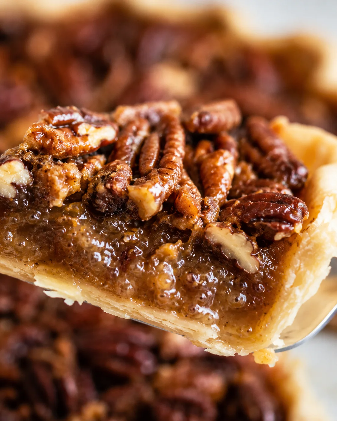 Macro view of pecan pie interior showing bubbly gooey filling and pecan texture