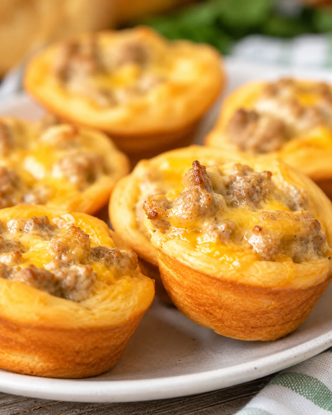 Side view of sausage and cream cheese biscuit bites on a plate